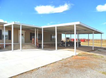 Large 40ftx24ft Galvanized steel framed 4-car carport with 15ft patio cover attached.
