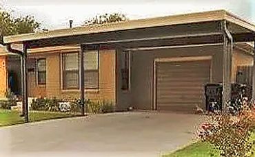 20c20ft attached aluminum rolled formed carport that is bronze with wheat color canopy top. OKC