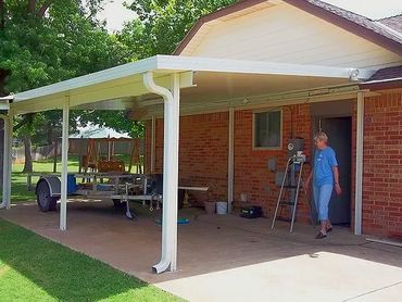 Attached 12ft X 20ft Lean-too style 3-inch-thick aluminum Structural Insulated Panel (SAP) carport.