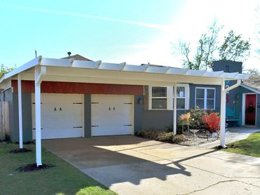 20ft X 20ft attached rolled formed steel flat pan carport with the Santa-Fe package trim added