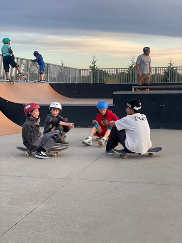 Skate Lessons Chicago Coach sitting with students at Palatine Park District Skateboarding Lessons