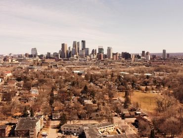 Aerial drone photo of the city of Minneapolis in Minnesota during the winter with brown trees.