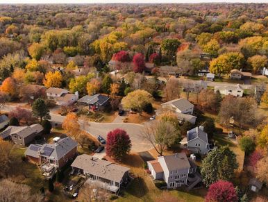 Aerial drone photo of a neighborhood with houses in Minnesota during the fall.