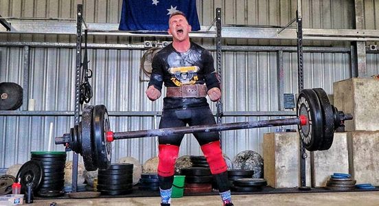 Unit VIII Gym Western Australia staff member and trainer Adam executing a lift in competition. 