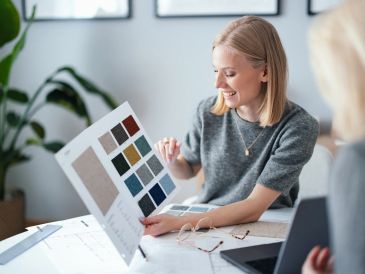 Woman reviewing fabric samples and color swatches.