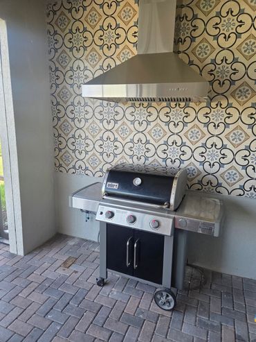 Exhaust hood and Backspkash added. Tile is set at height to allow a full outddor kitchen to be adde