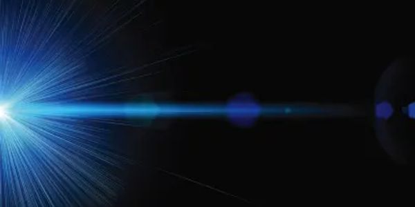 Bright blue lens flare on black background.