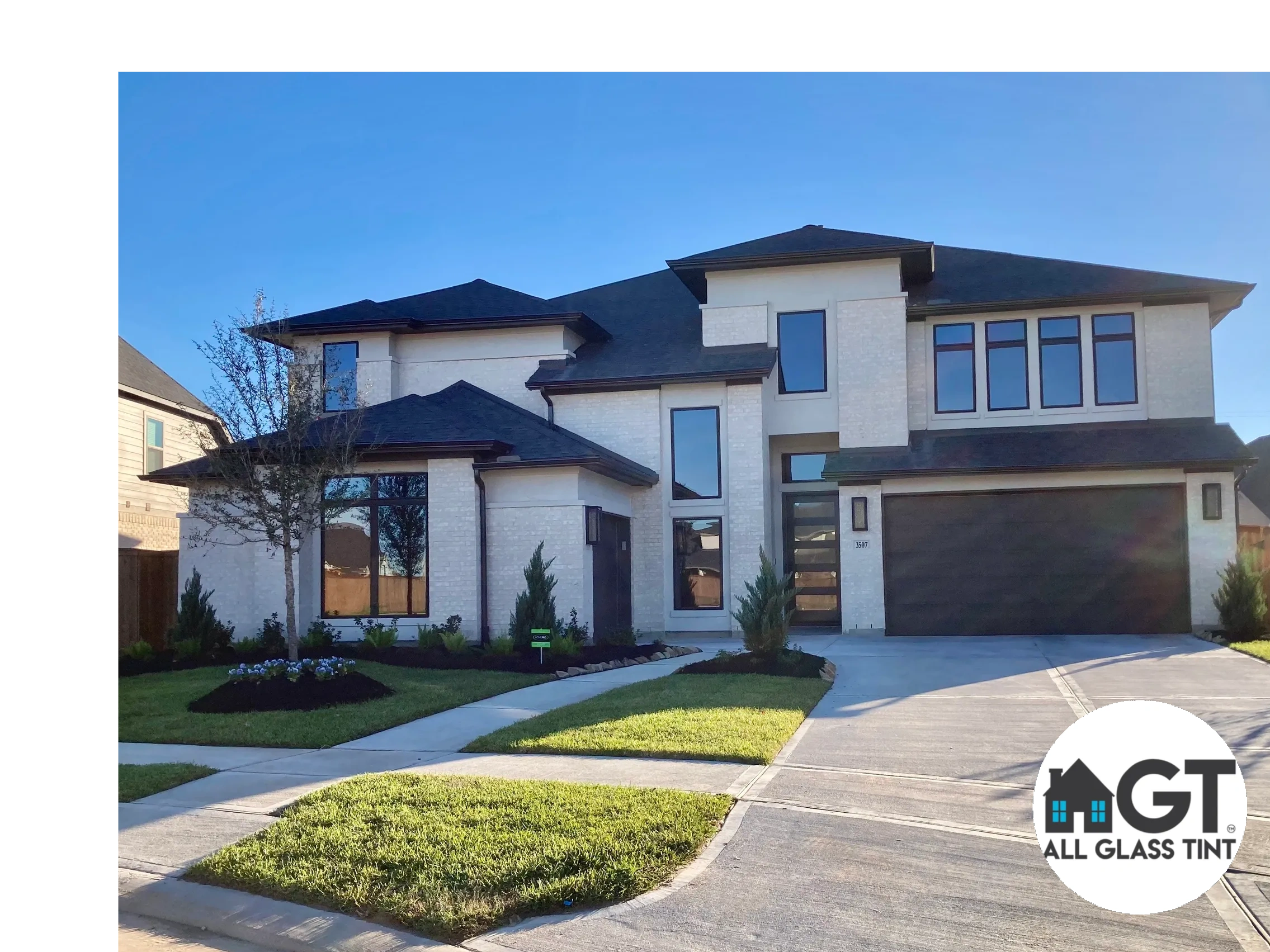 Two Story house with large dark windows