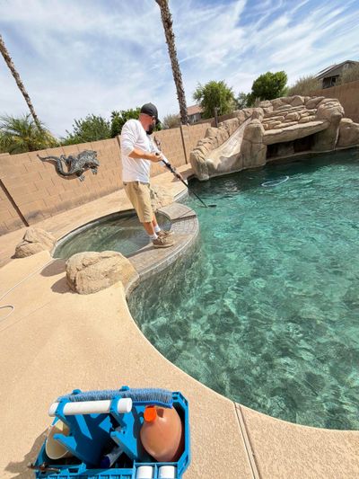 Jayce cleaning a pool, kit in the foreground