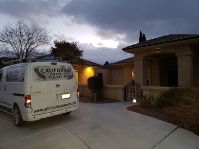 Mobile locksmithing van outside a residential house. Servicing all areas of the high desert.