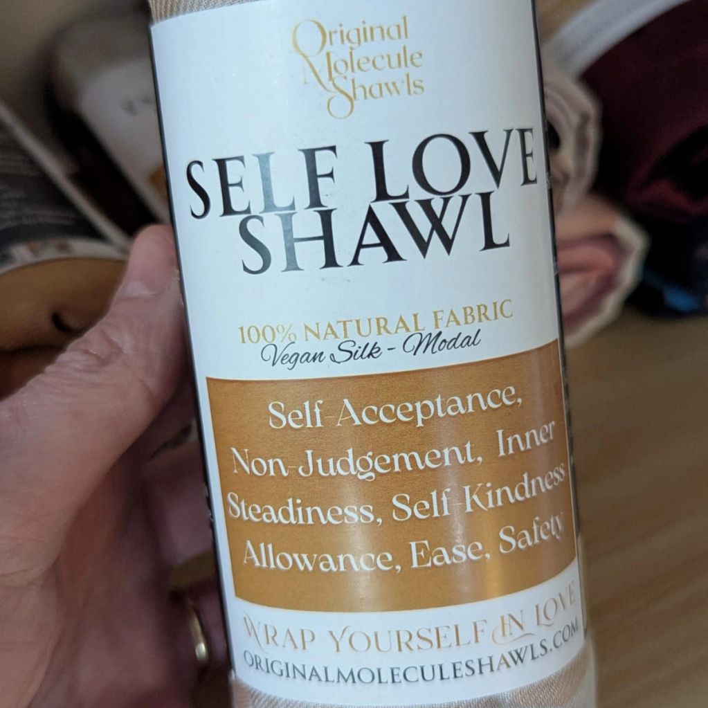 Label of a self-love shawl made from 100% natural fabric.