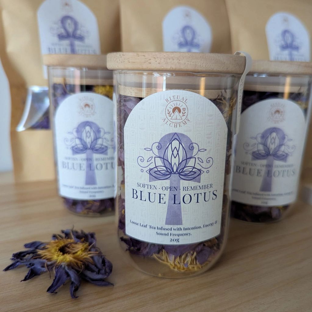 Jars of Blue Lotus tea on a wooden surface.