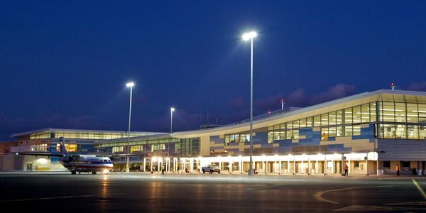 Airport terminal building lit up at night.