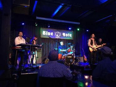 A band performs live at Blue Note Napa with vibrant stage lighting.