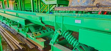 long run heavy-duty vibratory conveyor redirecting wood chips for loading and boiler fuel. www.vibra