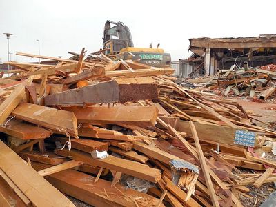 Recycling and reclaiming lumber from demolition before sorting in a vibrating screener.