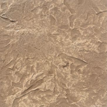 Close-up of rough, textured brown surface resembling dried earth or rock.
