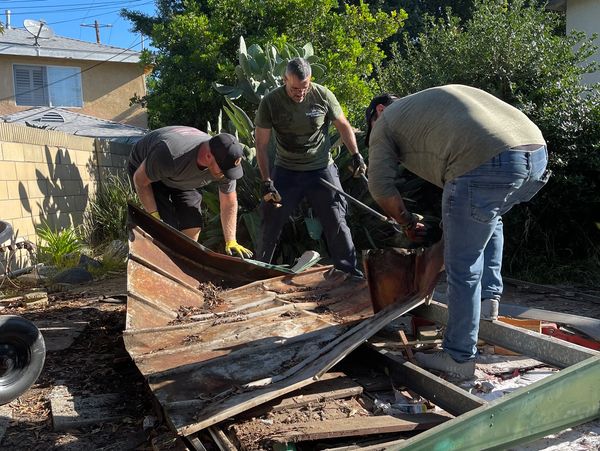 Ocho assists to demolish a hazardous shed in the home of a 100 year old WWII Veteran. OTCF EVENT