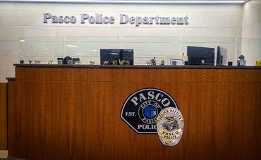 Sign installation behind front desk for Pasco Police Department