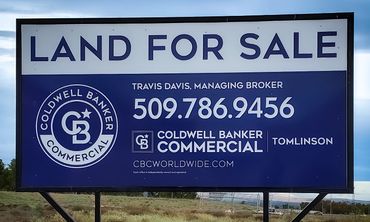 Sign that says "LAND FOR SALE" for Coldwell Banker Commercial