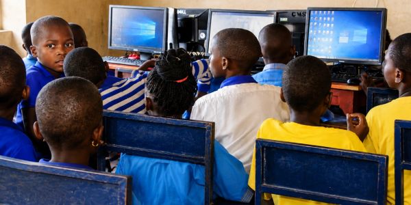 Children learning on computers in a classroom.
