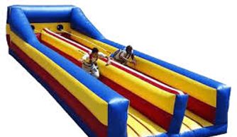 Two kids racing on a colorful inflatable slide.