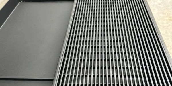 Close-up of a black metal grate with parallel lines.