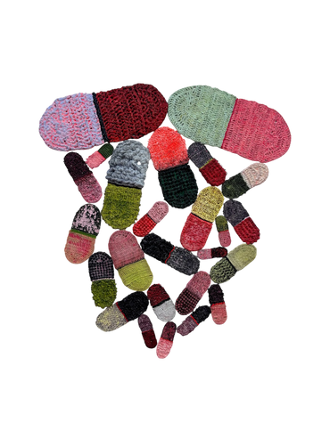 Collection of colorful crocheted pill-shaped objects on a black background.