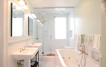 Large en suite professionally designed master bathroom renovation by Nest + Feather Home Staging