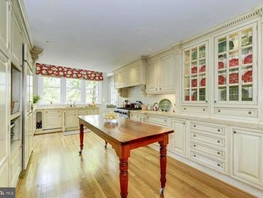 Nest and Feather staged this luxury kitchen to highlight the custom cabinetry and beautiful table