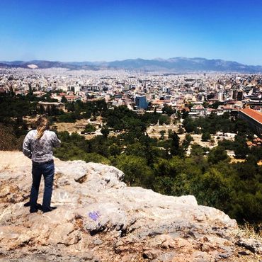 Cal the Stoner in a photo at a scenic location that looks out over Athens, Greece & the Acropolis.