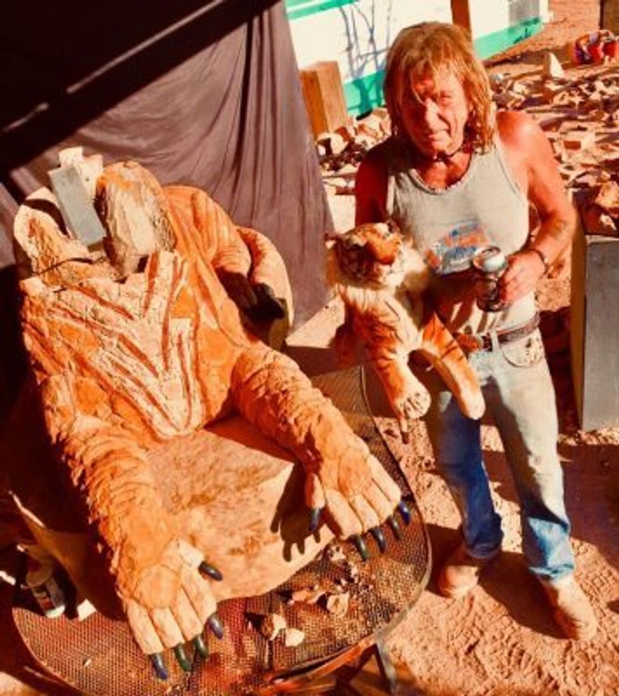 Cal the Stoner poses with The Andamooka Tiger in progress & his tiger plushie in the open-air studio