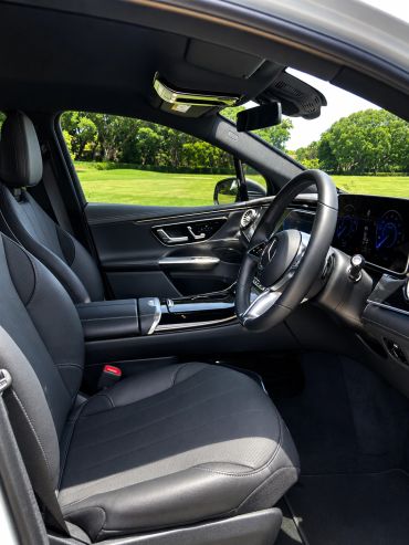 Interior of a modern luxury car with black leather seats.