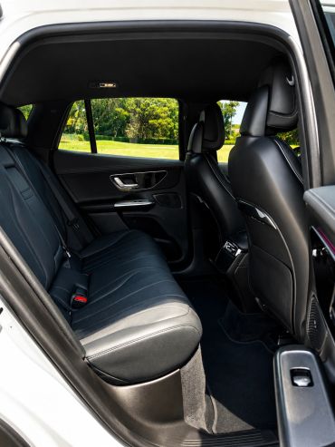 Backseat view of a car interior with black leather seats.
