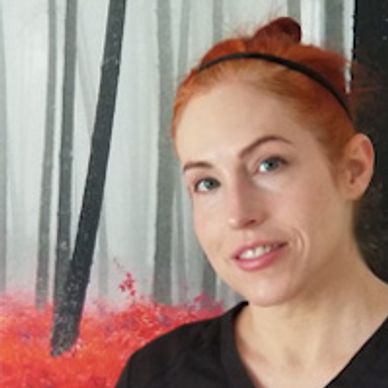 Woman smiling in front of a painting