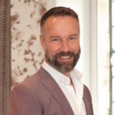 Man wearing a suit and smiling