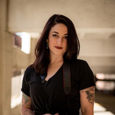 Woman wearing black looking at the camera