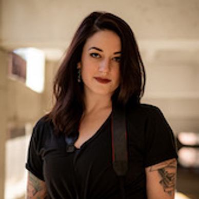 Woman wearing black looking directly at the camera