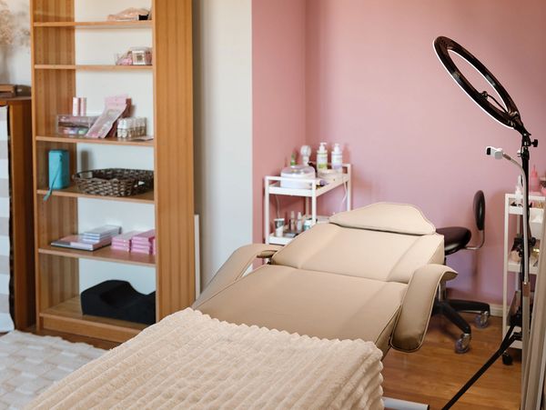 Cozy beauty treatment room with a comfortable reclining chair and soft blanket.