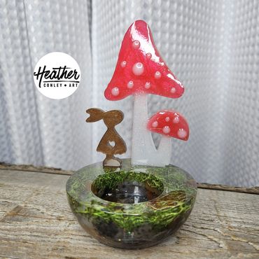 Handcrafted resin candle holder with red toadstool mushrooms, natural moss, and polished agates.