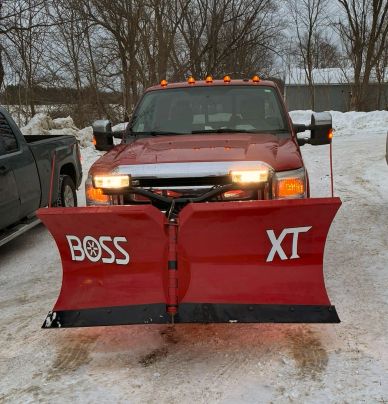 A truck with a snow plow.