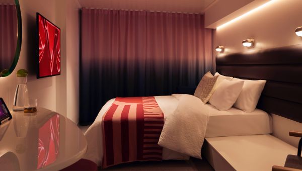 Cozy modern bedroom with warm lighting and red accents.