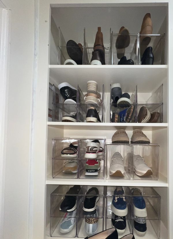 Clear shoe organizers on shelves neatly store various shoes.