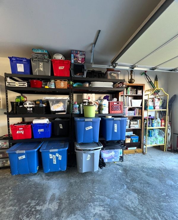 Organized garage shelves with labeled storage bins and household supplies.