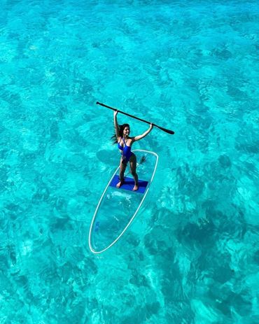 girl on a transparent paddleboard