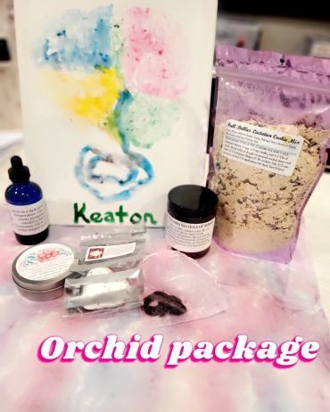 Orchid placenta package with newborn care products and a colorful painting.