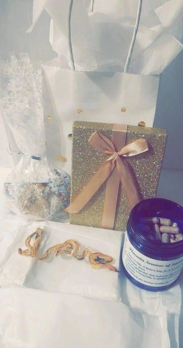 Gift bag, glittery wrapped present, capsules, and dried fruit.