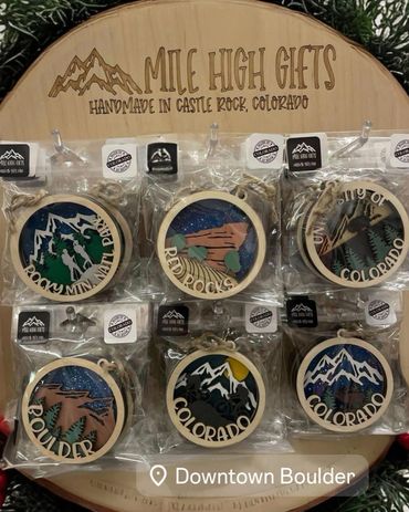 Handmade wood ornaments with different sayings- some say Colorado, some Rocky Mountain National Park