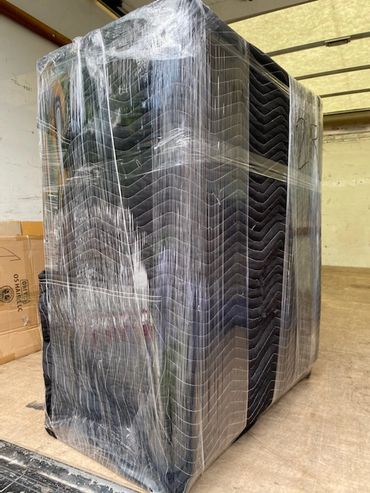 A shrink wrapped furniture item for transport