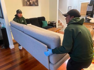 JYR Junk Removal crew lifting a couch during residential junk removal in San Francisco